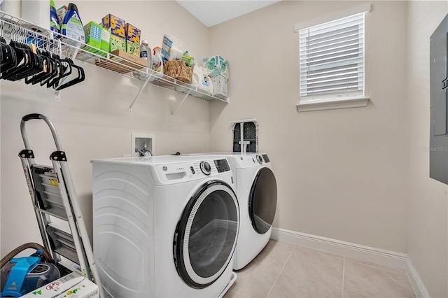 laundry area featuring light tile patterned floors and washing machine and dryer