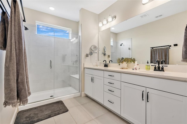 bathroom featuring tile patterned flooring, vanity, and a shower with shower door