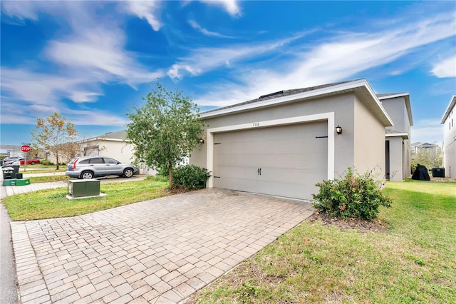 view of home's exterior with a garage and a yard