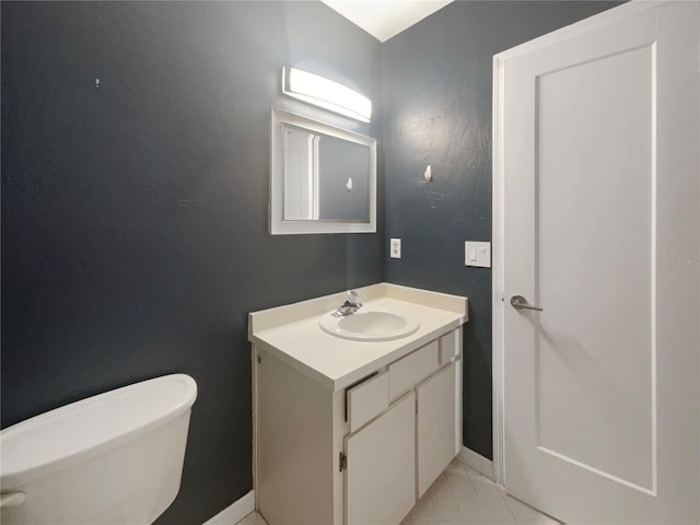 bathroom featuring tile patterned floors, vanity, and toilet