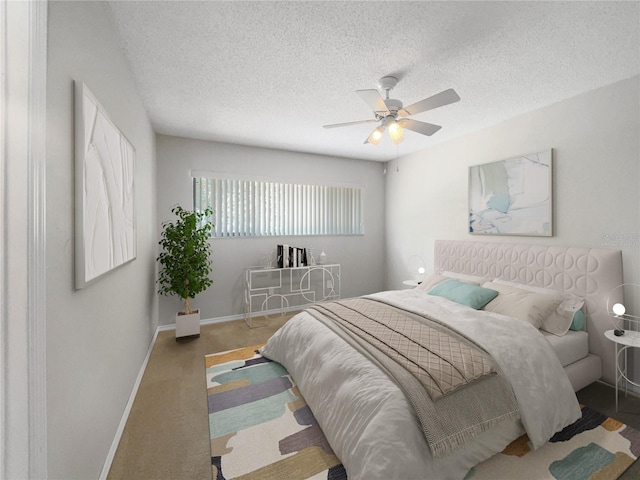 carpeted bedroom featuring ceiling fan and a textured ceiling