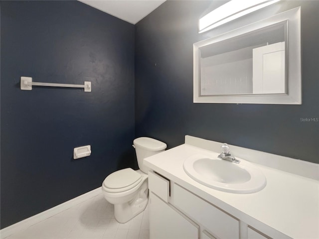 bathroom featuring tile patterned flooring, vanity, and toilet