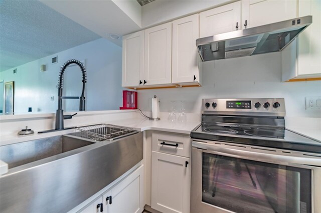 kitchen featuring sink, white cabinetry, and stainless steel range with electric cooktop