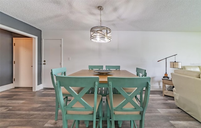 dining area featuring dark hardwood / wood-style floors and a textured ceiling