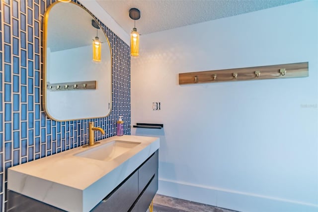 bathroom featuring a textured ceiling, vanity, tile walls, and decorative backsplash