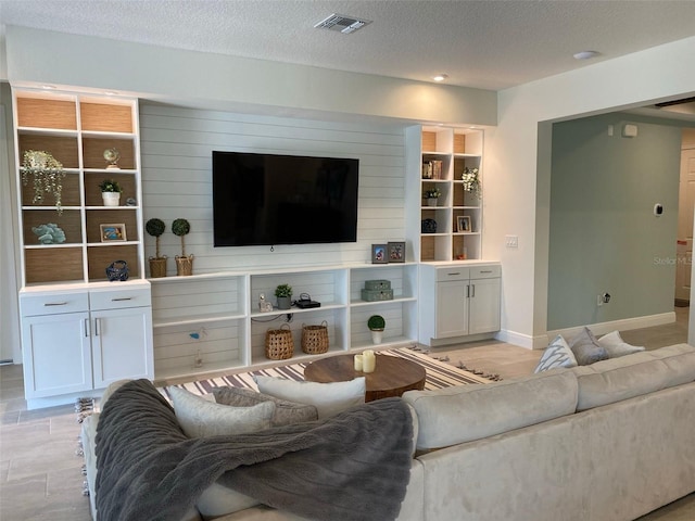 tiled living room with a textured ceiling