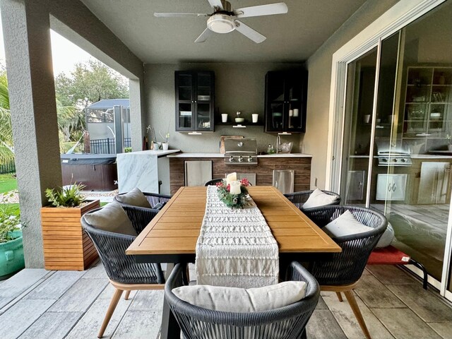 exterior space featuring area for grilling, sink, ceiling fan, and exterior kitchen