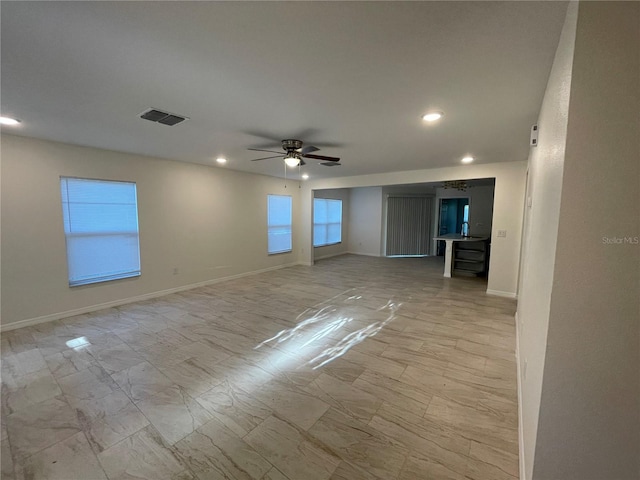 unfurnished room featuring visible vents, ceiling fan, and baseboards