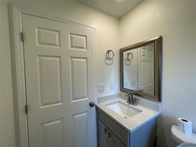 bathroom featuring toilet and vanity