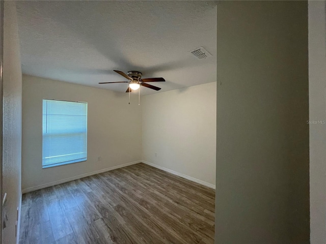 unfurnished room featuring a textured ceiling, ceiling fan, and hardwood / wood-style floors