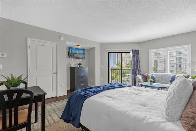 bedroom featuring hardwood / wood-style flooring and a textured ceiling