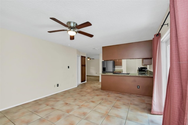 interior space featuring light tile patterned floors and ceiling fan