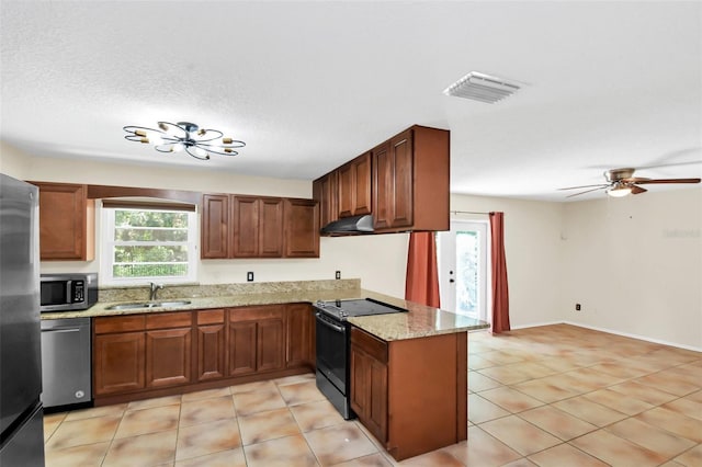 kitchen featuring light tile patterned floors, kitchen peninsula, sink, and appliances with stainless steel finishes