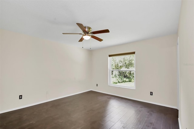 unfurnished room featuring ceiling fan and dark hardwood / wood-style flooring