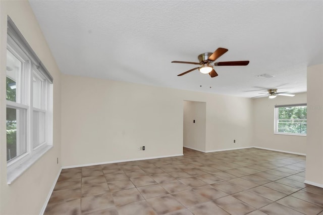 spare room with ceiling fan and a textured ceiling