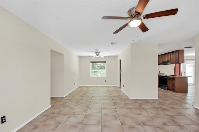 tiled spare room featuring ceiling fan