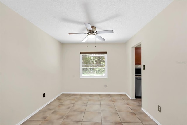 empty room featuring light tile patterned floors, a textured ceiling, and ceiling fan