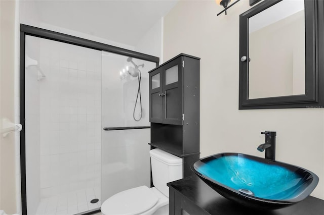 bathroom with vanity, toilet, and walk in shower