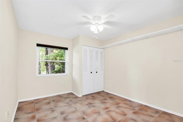 unfurnished bedroom featuring ceiling fan, a closet, and light tile patterned flooring