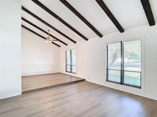 spare room featuring beam ceiling, hardwood / wood-style flooring, high vaulted ceiling, and ceiling fan