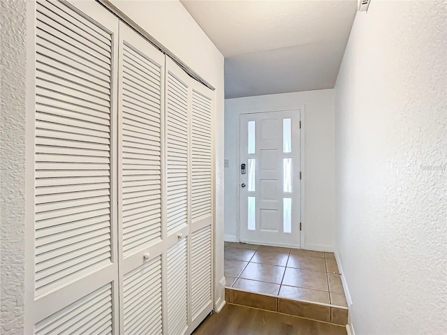 entryway featuring dark tile patterned flooring