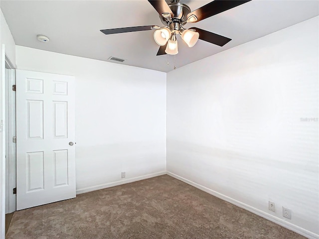 carpeted spare room with ceiling fan