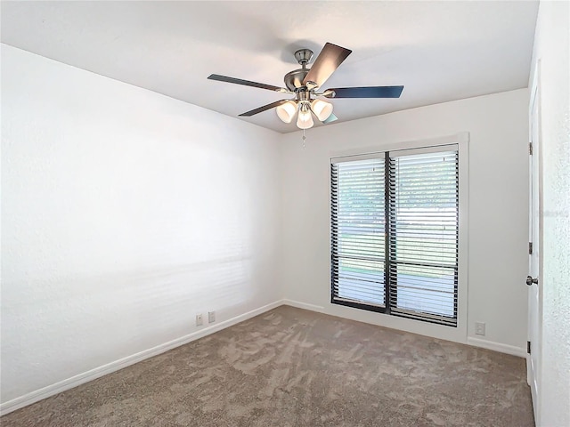 carpeted spare room featuring ceiling fan