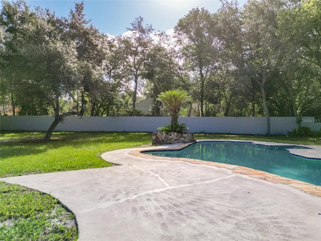 view of pool with a yard