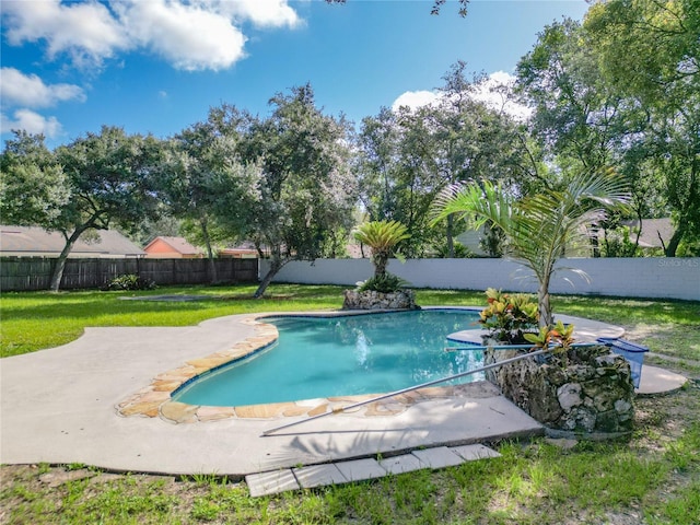 view of swimming pool featuring a lawn and a patio