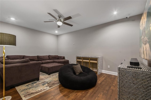 living area with recessed lighting, ceiling fan, baseboards, and wood finished floors