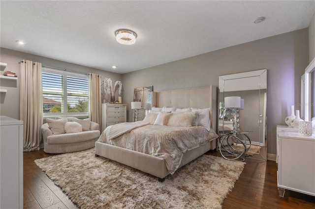 bedroom featuring dark wood-style floors and baseboards