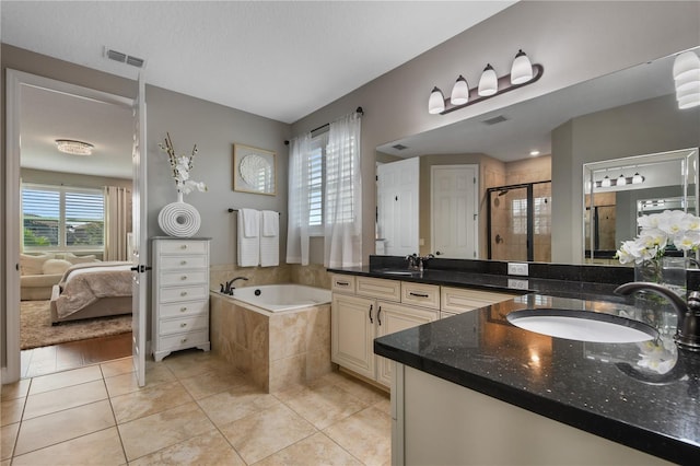 bathroom featuring a garden tub, tile patterned flooring, a shower stall, and visible vents