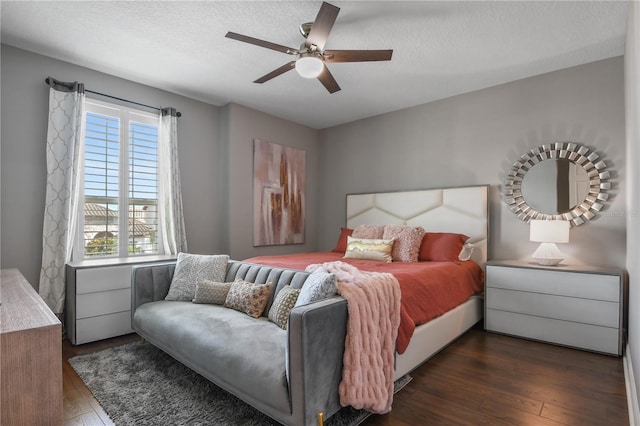 bedroom featuring a textured ceiling, multiple windows, and dark wood finished floors