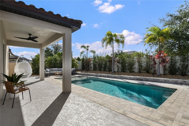 view of swimming pool with a ceiling fan, a patio area, an outdoor living space, and a fenced backyard