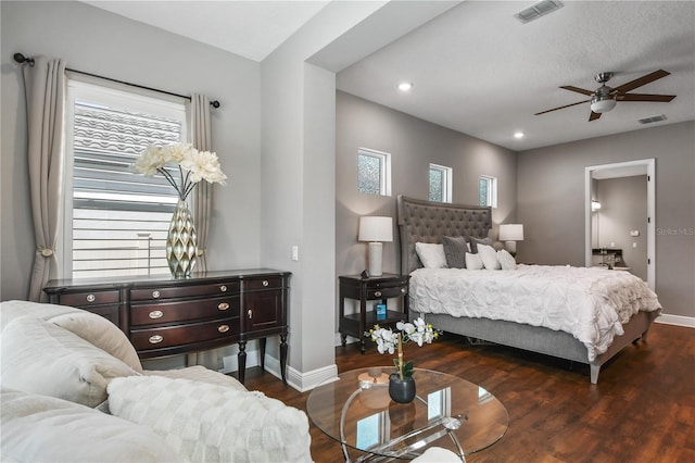 bedroom featuring dark wood-style floors, baseboards, and visible vents