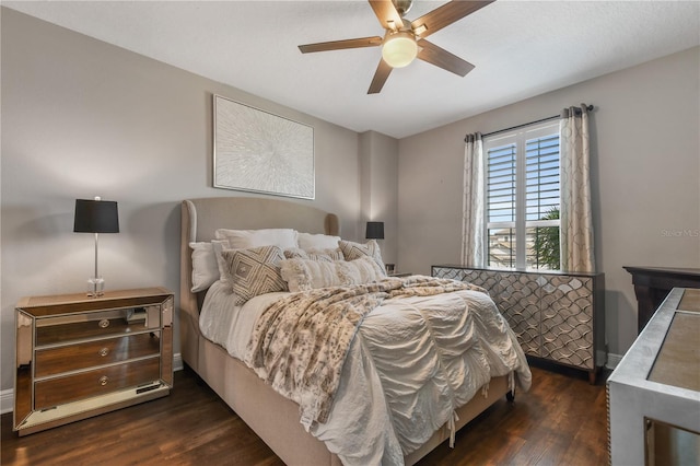 bedroom with dark wood-style floors and a ceiling fan