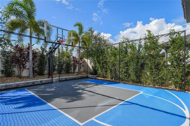 view of basketball court with community basketball court and fence