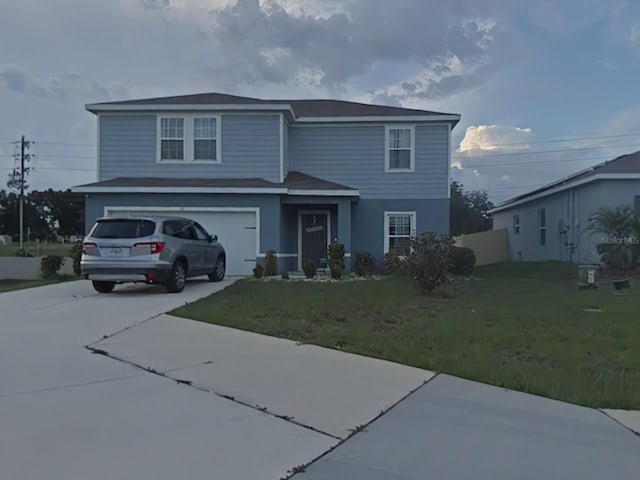 view of property featuring a garage and a front lawn