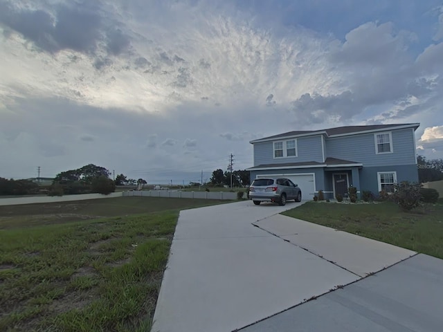 view of front of property featuring a garage and a front yard