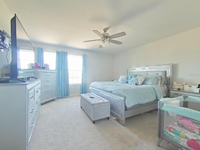 bedroom featuring light colored carpet and ceiling fan