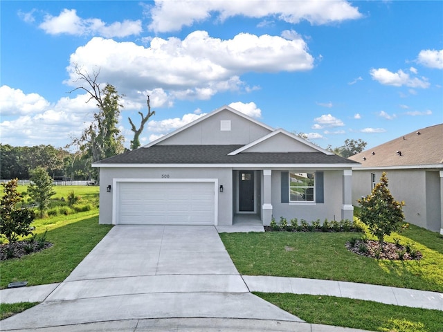 view of front of home featuring a front yard and a garage