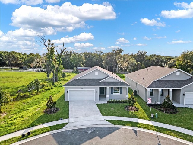 view of front of house featuring a garage and a front lawn