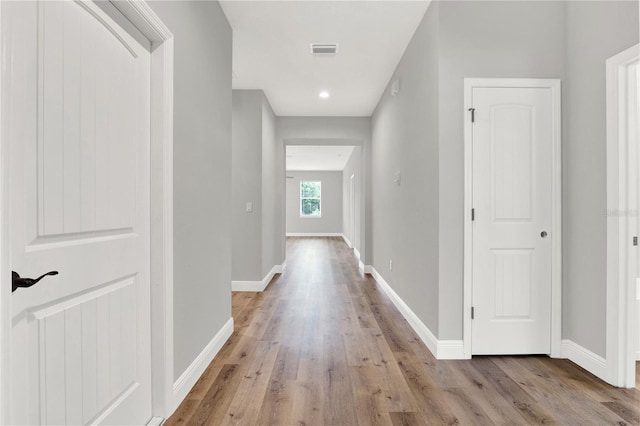 corridor with light hardwood / wood-style flooring