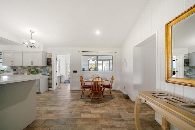 dining space featuring an inviting chandelier and lofted ceiling