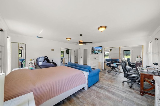 bedroom with ornamental molding, ceiling fan, and light hardwood / wood-style flooring