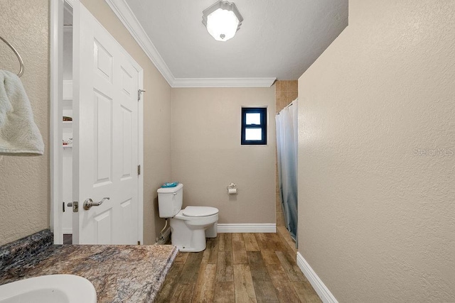 bathroom with wood-type flooring, toilet, crown molding, and a shower with curtain