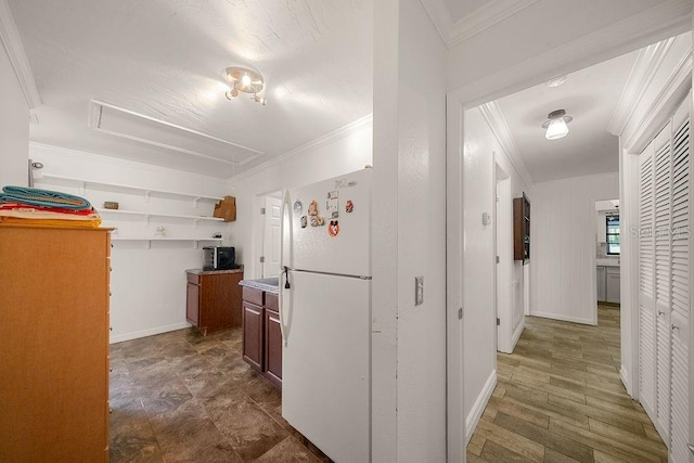 kitchen featuring ornamental molding and white fridge