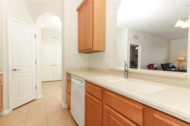 kitchen with sink, light tile patterned floors, and white dishwasher