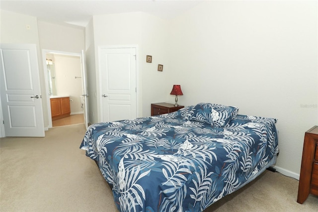 carpeted bedroom featuring ensuite bathroom