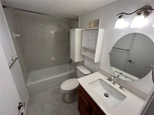 full bathroom featuring tiled shower / bath combo, vanity, toilet, and tile patterned flooring